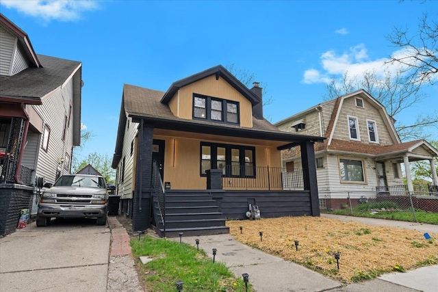 475 Algonquin St, Detroit, MI 48215 - view of front of house featuring a porch, a chimney, and fence