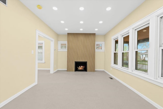 475 Algonquin St, Detroit, MI 48215 - unfurnished living room featuring light carpet, recessed lighting, baseboards, and a large fireplace