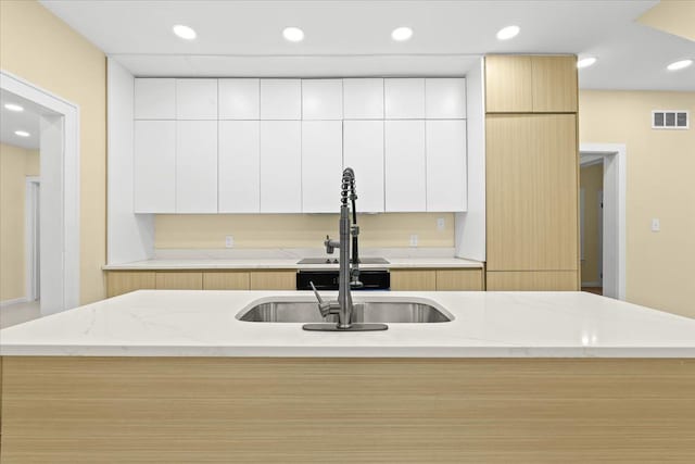 475 Algonquin St, Detroit, MI 48215 - kitchen with modern cabinets, recessed lighting, light stone countertops, white cabinets, and a sink