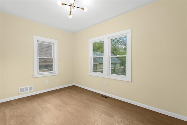 475 Algonquin St, Detroit, MI 48215 - spare room featuring wood finished floors, baseboards, and a chandelier