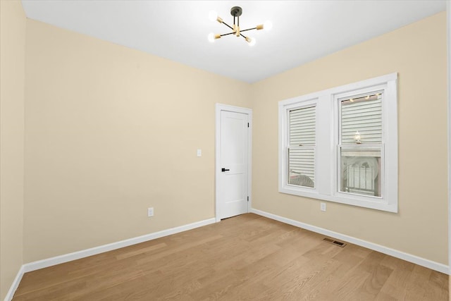 475 Algonquin St, Detroit, MI 48215 - unfurnished room featuring a chandelier, light wood-style floors, and baseboards