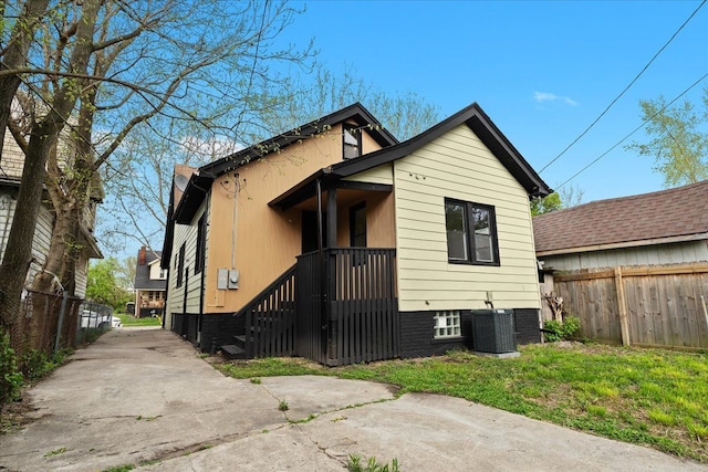 475 Algonquin St, Detroit, MI 48215 - back of property with central AC unit, fence, and concrete driveway