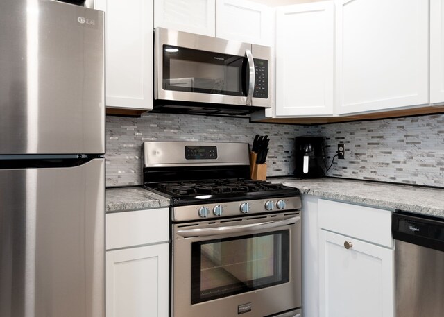 2170 Sonoma St, Ferndale, MI 48220 - kitchen featuring appliances with stainless steel finishes, white cabinets, and backsplash