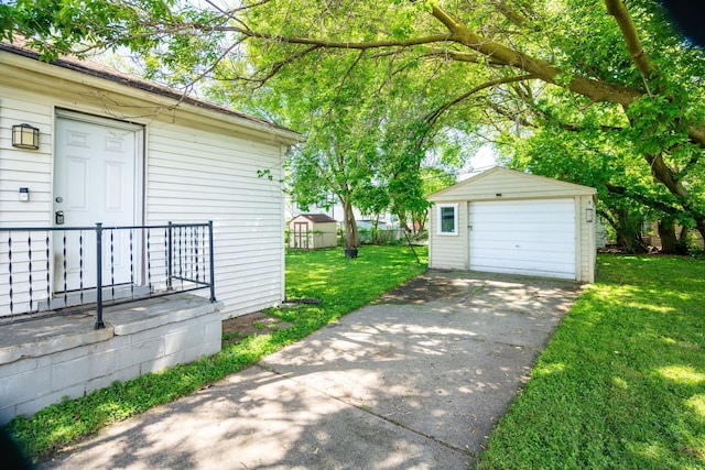 2170 Sonoma St, Ferndale, MI 48220 - view of green lawn with an outdoor structure, a garage, and driveway