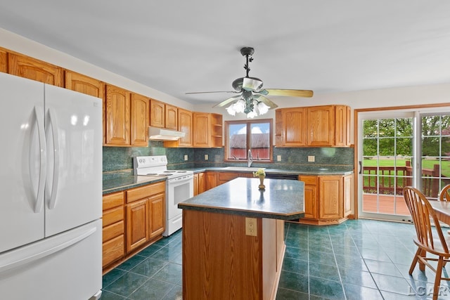 11160 W Ridgeville Rd, Morenci, MI 49256 - kitchen featuring white appliances, decorative backsplash, under cabinet range hood, dark countertops, and a ceiling fan