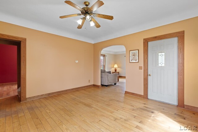 11160 W Ridgeville Rd, Morenci, MI 49256 - entryway with arched walkways, light wood-style floors, ceiling fan, and baseboards