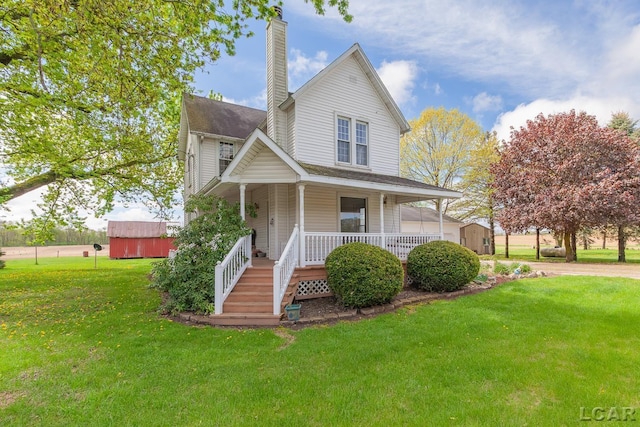 11160 W Ridgeville Rd, Morenci, MI 49256 - farmhouse with a storage shed, a chimney, a porch, a front yard, and an outdoor structure