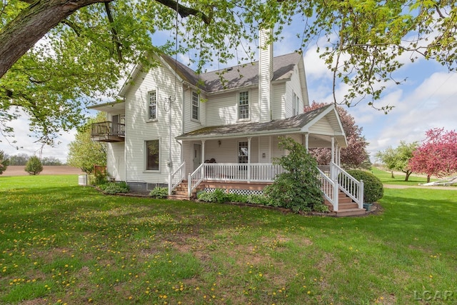 11160 W Ridgeville Rd, Morenci, MI 49256 - view of front of house featuring covered porch, a chimney, and a front yard
