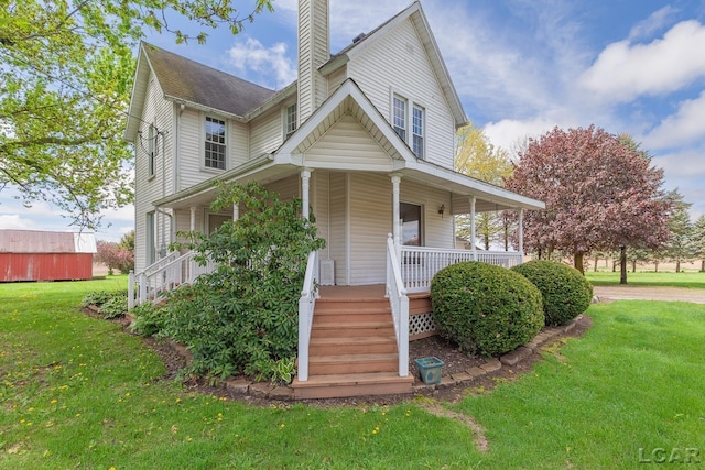 11160 W Ridgeville Rd, Morenci, MI 49256 - view of front facade featuring a chimney, covered porch, and a front yard