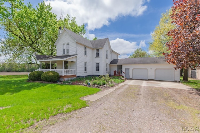 11160 W Ridgeville Rd, Morenci, MI 49256 - view of front of property with concrete driveway, a garage, covered porch, and a front lawn