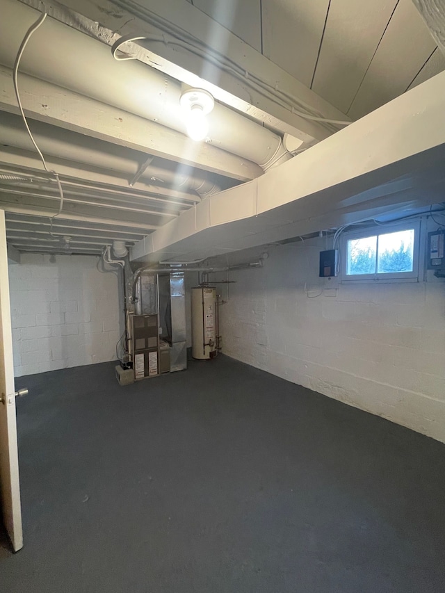 basement featuring water heater, heating unit, and concrete block wall
