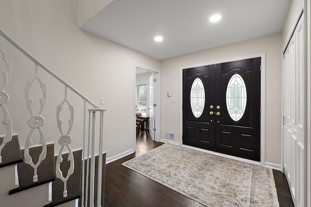foyer featuring dark wood-style flooring, baseboards, recessed lighting, and stairway