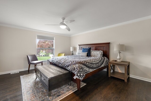 bedroom featuring baseboards, crown molding, wood finished floors, and ceiling fan