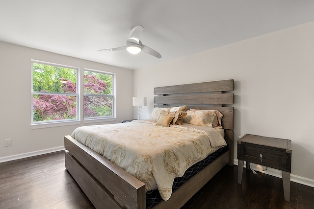 bedroom featuring baseboards, wood finished floors, and a ceiling fan