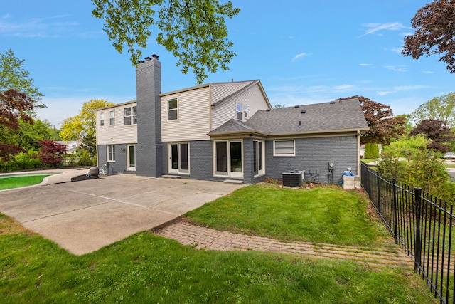 4573 Ranch Ln, Bloomfield Hills, MI 48302 - rear view of property with cooling unit, a patio, a chimney, and brick siding