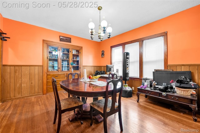 414 Riverview Ave, Monroe, MI 48162 - dining space with wainscoting, wooden walls, a chandelier, and hardwood / wood-style floors