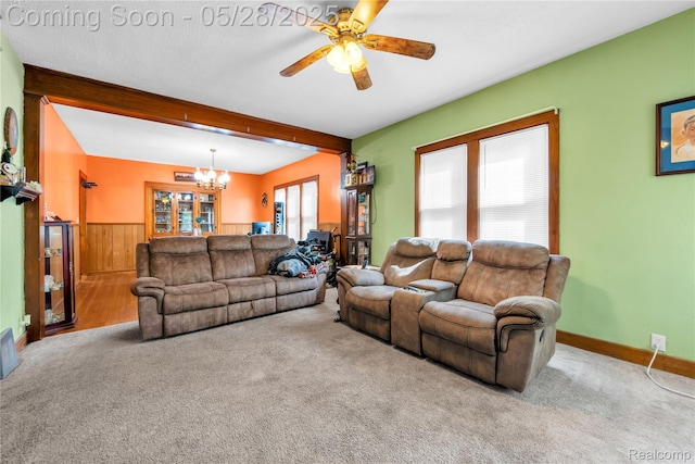 414 Riverview Ave, Monroe, MI 48162 - carpeted living room featuring a chandelier, a ceiling fan, beamed ceiling, wainscoting, and wooden walls