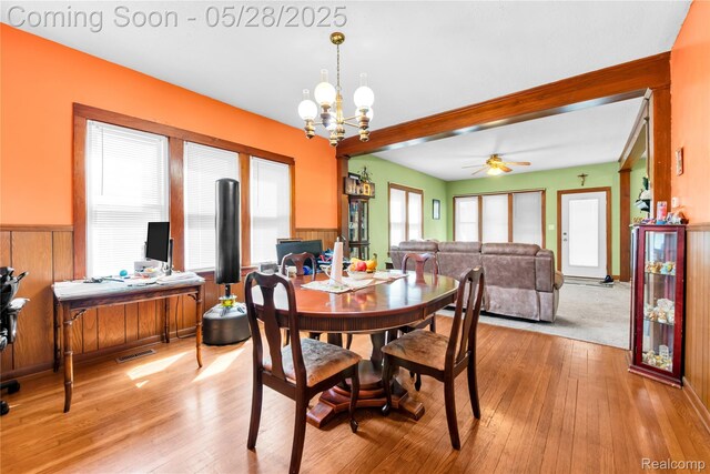 414 Riverview Ave, Monroe, MI 48162 - dining space with light wood-style flooring, a desk, a chandelier, a ceiling fan, and wainscoting