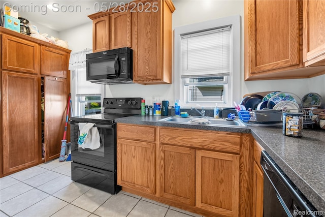 414 Riverview Ave, Monroe, MI 48162 - kitchen featuring black appliances, a sink, plenty of natural light, and light tile patterned flooring