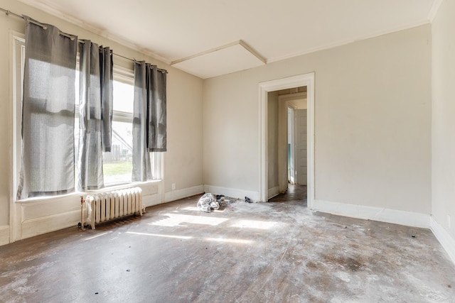 spare room featuring radiator, concrete flooring, and baseboards