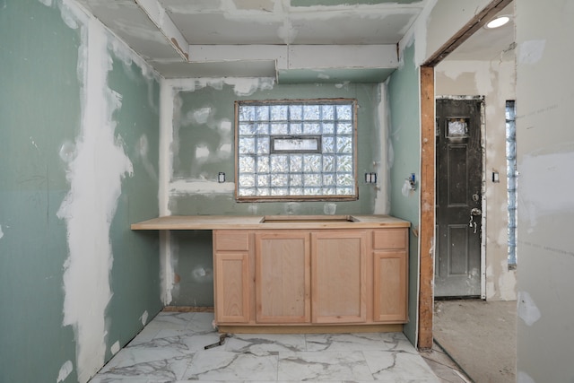 bathroom featuring a sink and marble finish floors