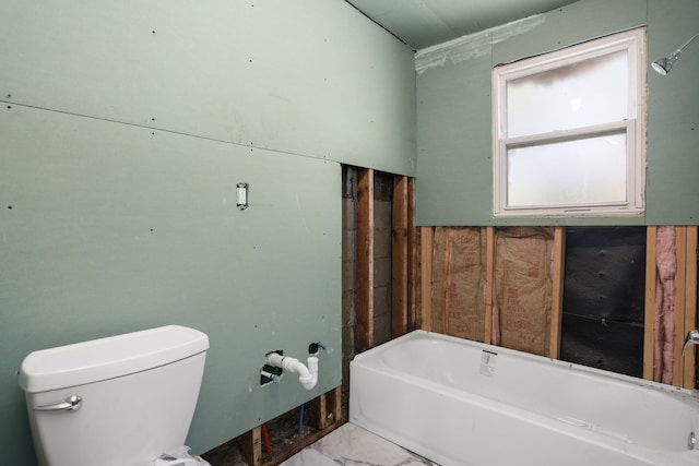 full bath with a bathtub, marble look tile flooring, and toilet