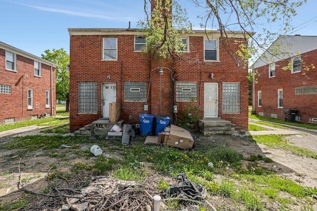 back of house with brick siding
