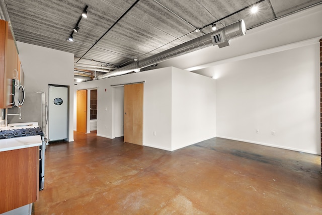 below grade area with rail lighting and baseboards