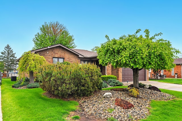 47296 Sanborn Dr, Macomb, MI 48044 - obstructed view of property with brick siding, driveway, a front yard, and a garage