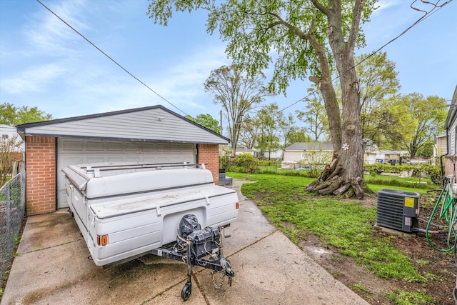 detached garage with fence and central air condition unit