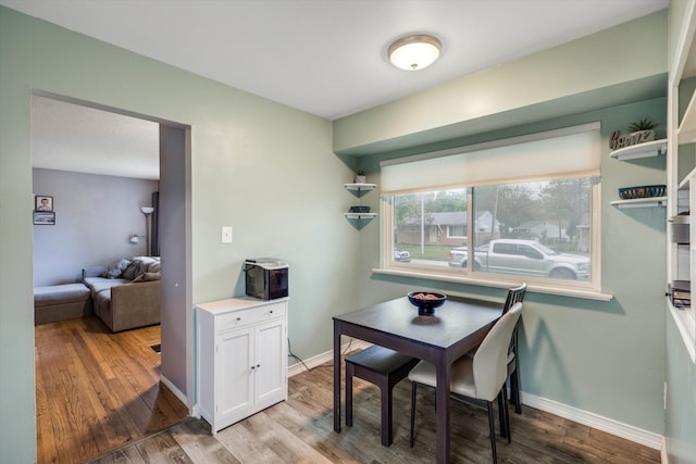 dining room with wood finished floors and baseboards