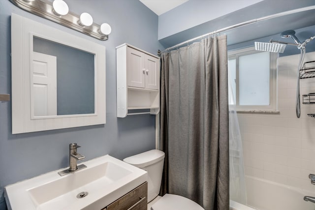 bathroom featuring toilet, shower / bath combo with shower curtain, and vanity