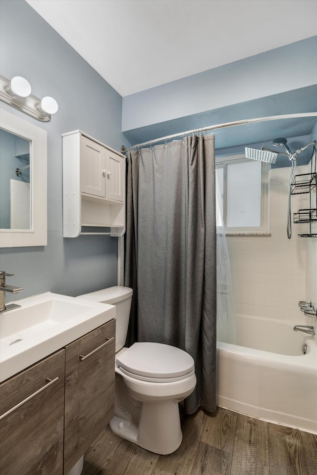 full bathroom featuring toilet, shower / bath combination with curtain, vanity, and wood finished floors