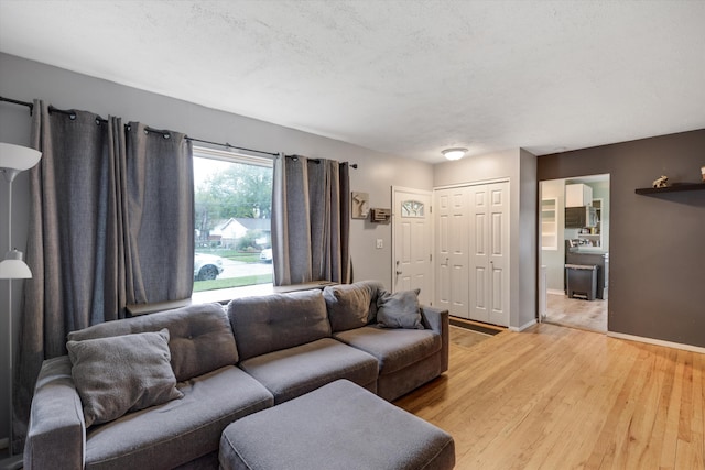 living room featuring light wood-style flooring and baseboards