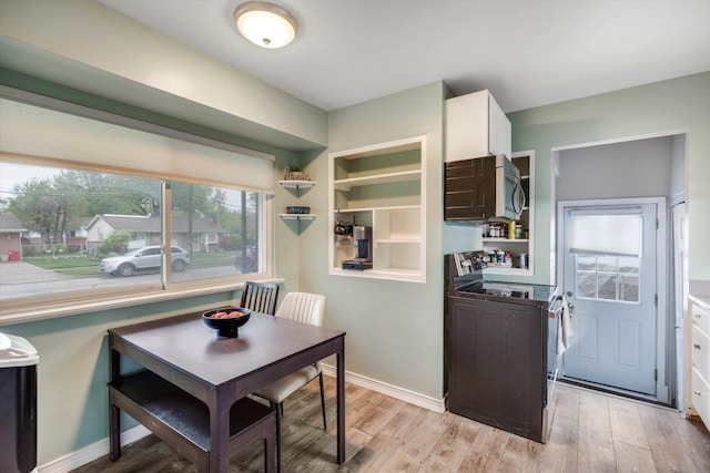 dining space with light wood finished floors and washer / clothes dryer