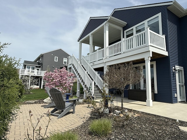 4497 Point Superior Ct, Holland, MI 49424 - back of house featuring a patio area, a balcony, and stairway