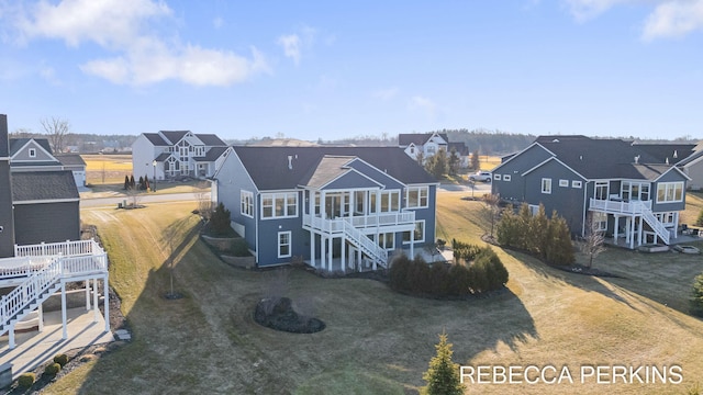 4497 Point Superior Ct, Holland, MI 49424 - back of house featuring stairs, a deck, a residential view, and a yard