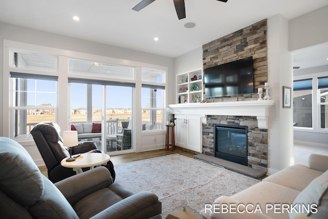 4497 Point Superior Ct, Holland, MI 49424 - living room featuring a ceiling fan, wood finished floors, a stone fireplace, and recessed lighting