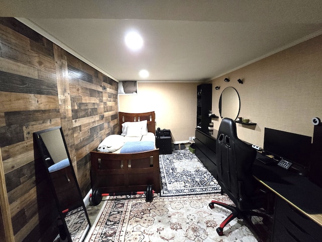 bedroom featuring wood walls, an office area, ornamental molding, and baseboards
