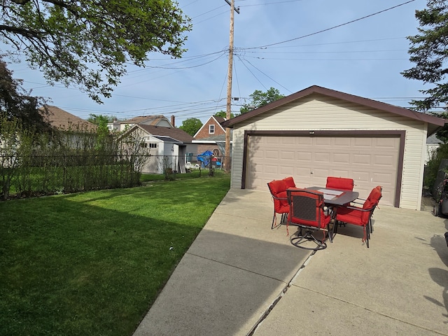 view of yard featuring a detached garage, an outdoor structure, a patio area, and outdoor dining area
