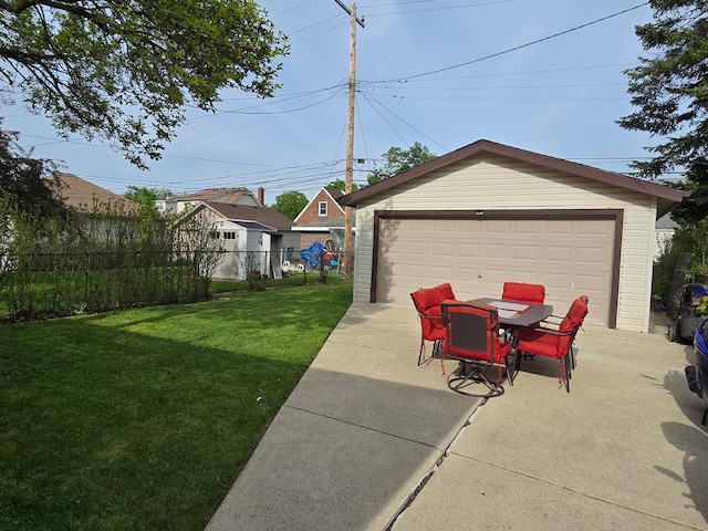view of yard with a garage, an outbuilding, outdoor dining area, and a patio area