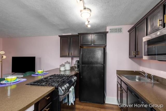 kitchen with black appliances, dark wood-type flooring, a sink, dark brown cabinetry, and a textured ceiling