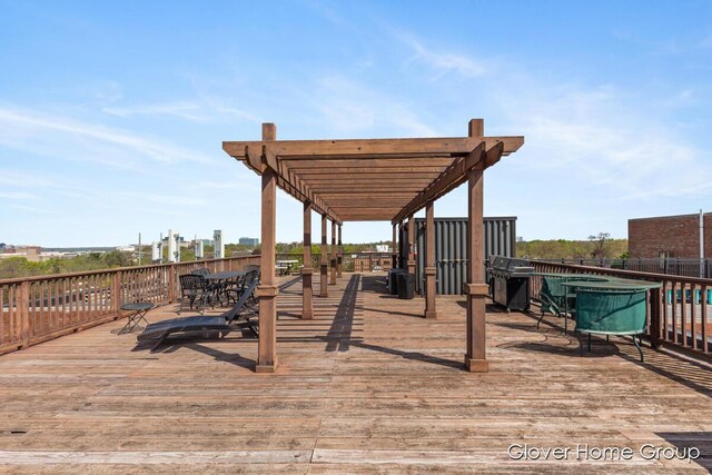 wooden deck with grilling area and outdoor dining space