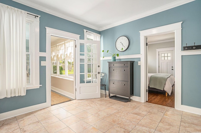 entryway featuring crown molding, baseboards, and tile patterned flooring