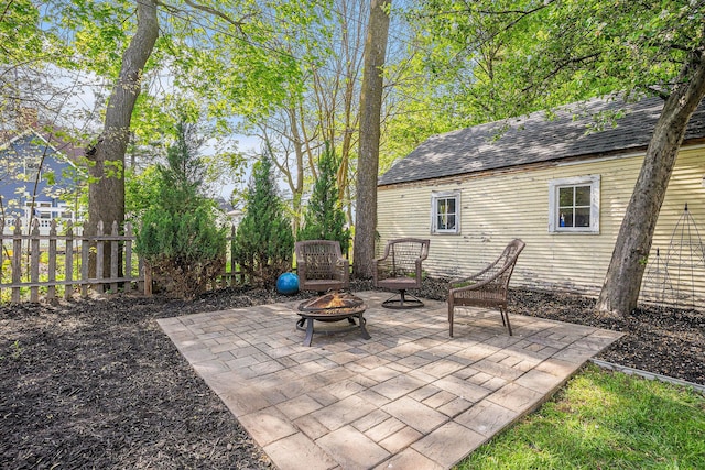 view of patio / terrace featuring a fire pit and fence