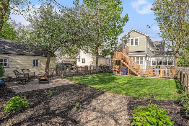 view of yard featuring stairs, a fire pit, and a patio area