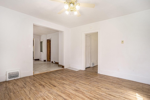 5128 Heights Ravenna Rd, Fruitport, MI 49415 - empty room featuring wood finished floors, a ceiling fan, and baseboards