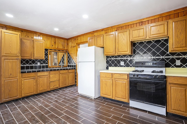 5128 Heights Ravenna Rd, Fruitport, MI 49415 - kitchen with range with gas cooktop, freestanding refrigerator, backsplash, recessed lighting, and tile counters