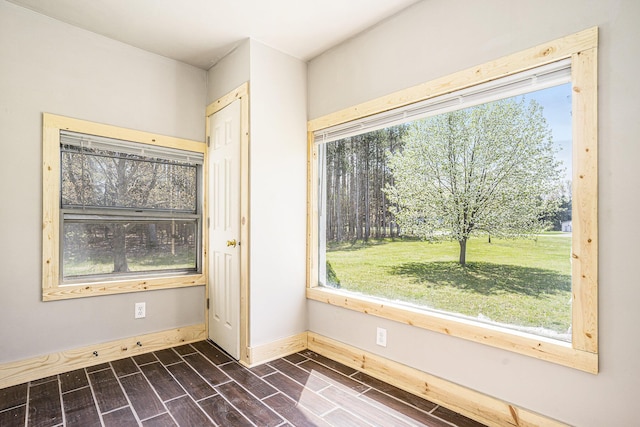 5128 Heights Ravenna Rd, Fruitport, MI 49415 - unfurnished room featuring healthy amount of natural light, dark wood finished floors, and baseboards