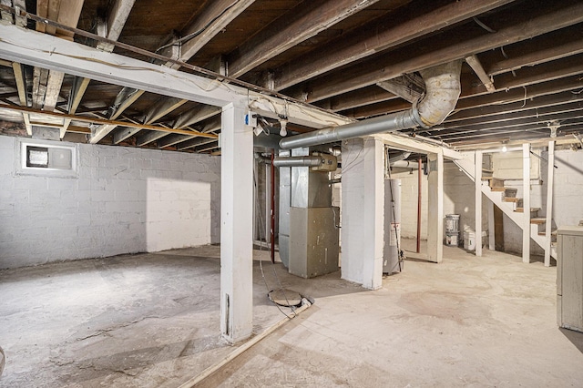5128 Heights Ravenna Rd, Fruitport, MI 49415 - unfinished below grade area featuring stairway, heating unit, and gas water heater